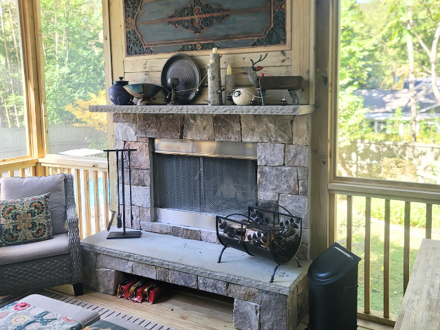 Luxury screened-in porch with stone fireplace built poolside in Alpharetta GA