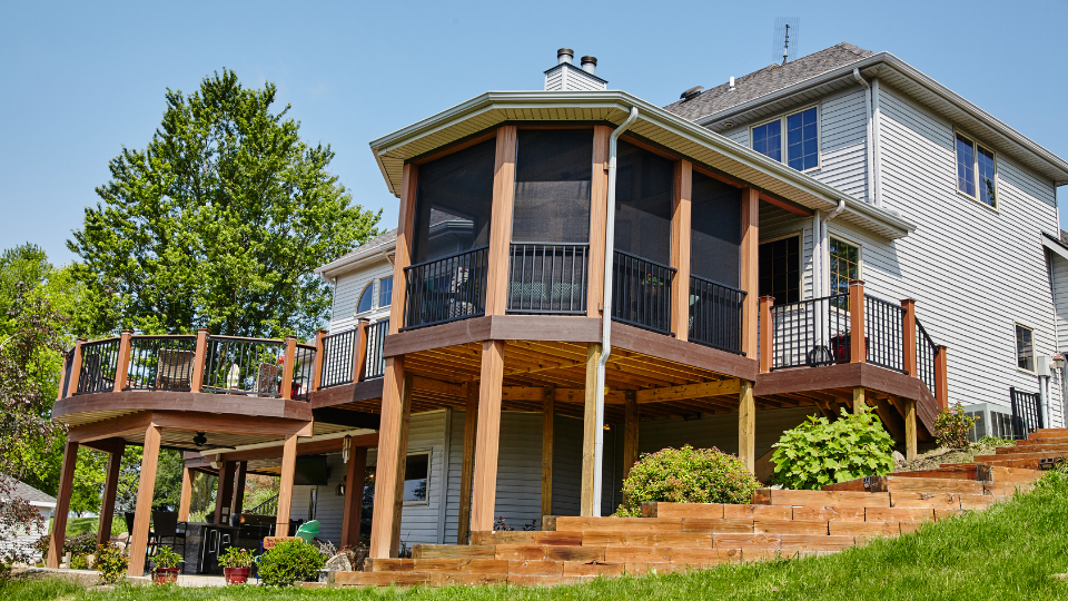 Custom screened porch and elevated deck built in Alpharetta, GA featuring durable wood posts, black railing, and spacious outdoor design.