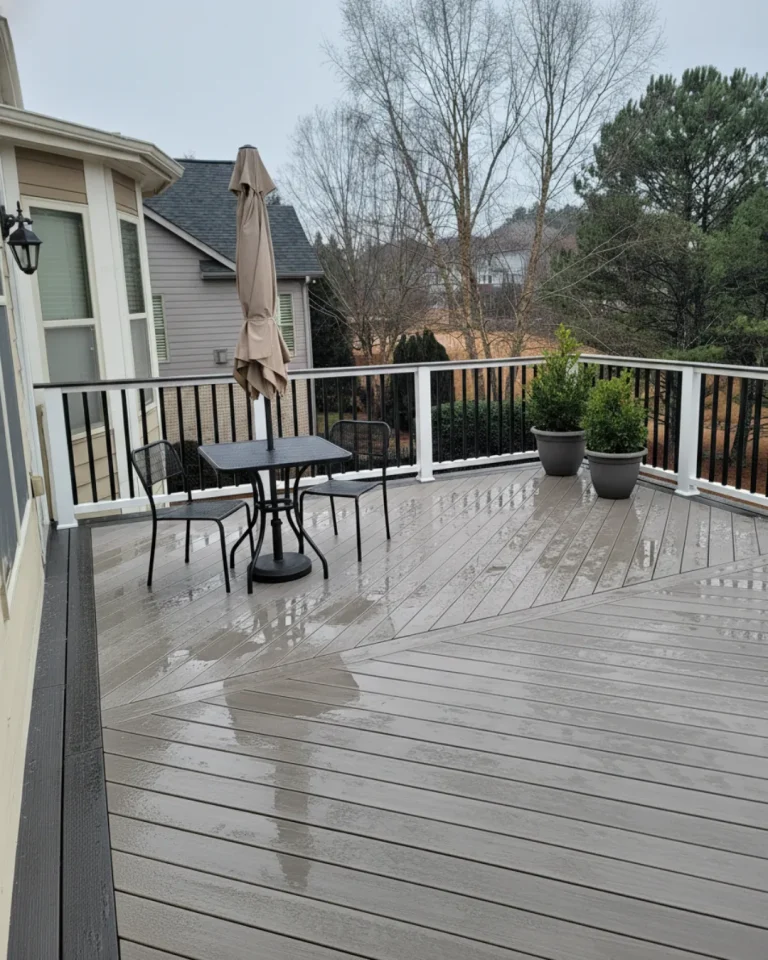Custom composite deck replacement in North Atlanta featuring a diagonal decking pattern, dark picture frame border, and modern black aluminum railing.