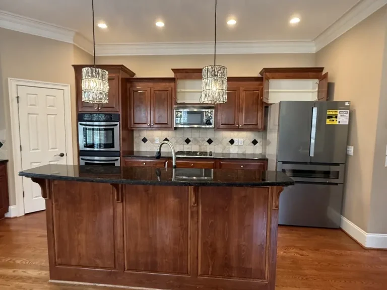 Before kitchen remodel in Alpharetta, GA with closed layout, wood cabinets, and limited counter space