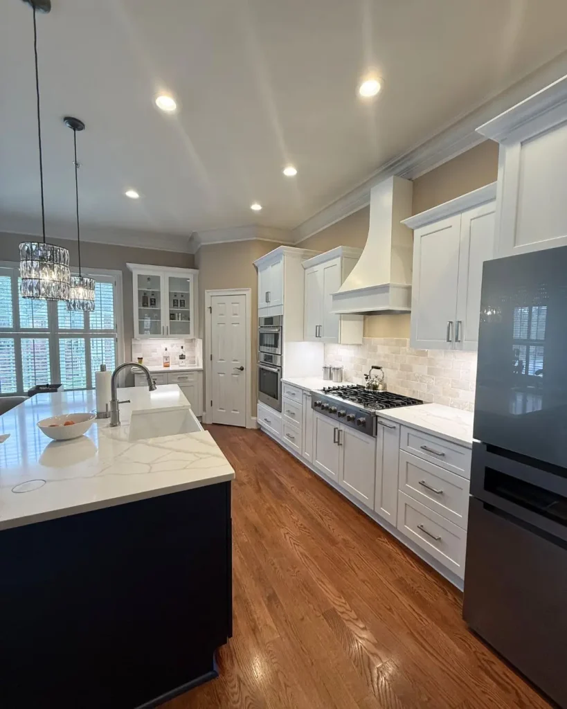 Open concept kitchen remodel in Alpharetta, GA with white cabinetry, quartz countertops, and modern layout