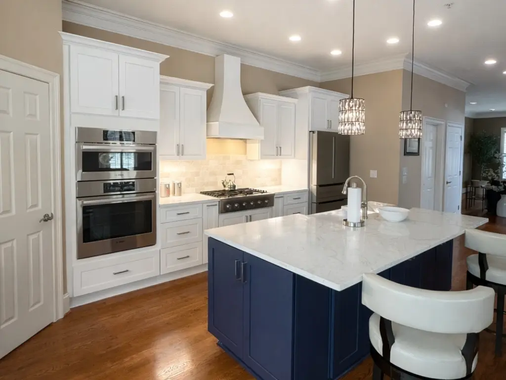 Custom kitchen remodeling in Alpharetta GA featuring white shaker cabinets, quartz countertops, and a navy island with seating by Yanover Construction