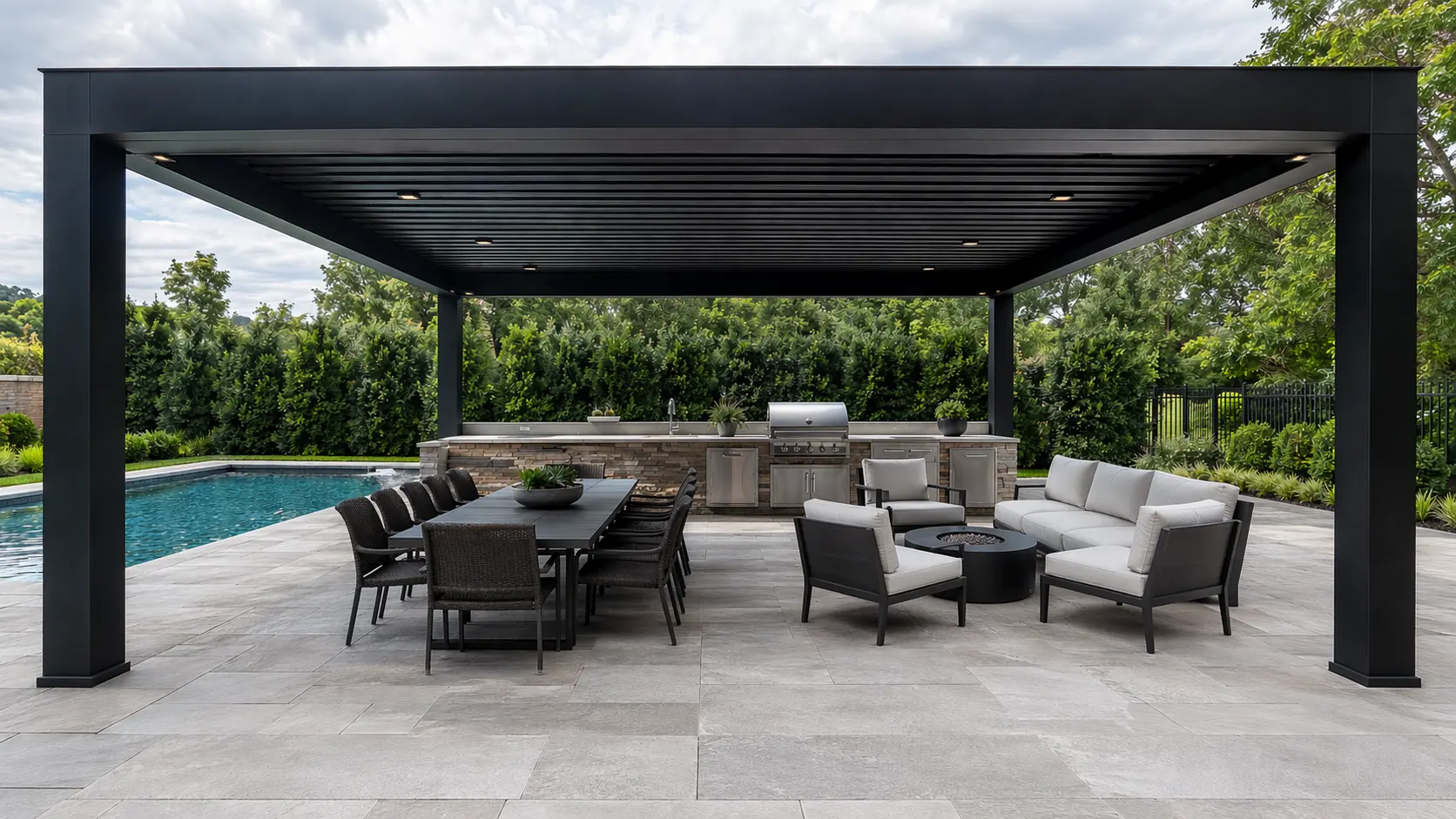 Luxury modern pergola with louvered roof, outdoor kitchen, and fire pit seating area in a high-end Milton GA backyard with pool and stone patio