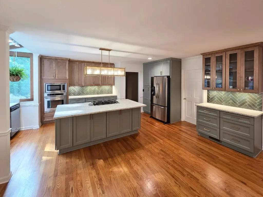 Custom kitchen remodel in Alpharetta, GA with large island, custom cabinetry, hardwood floors, and modern backsplash design.
