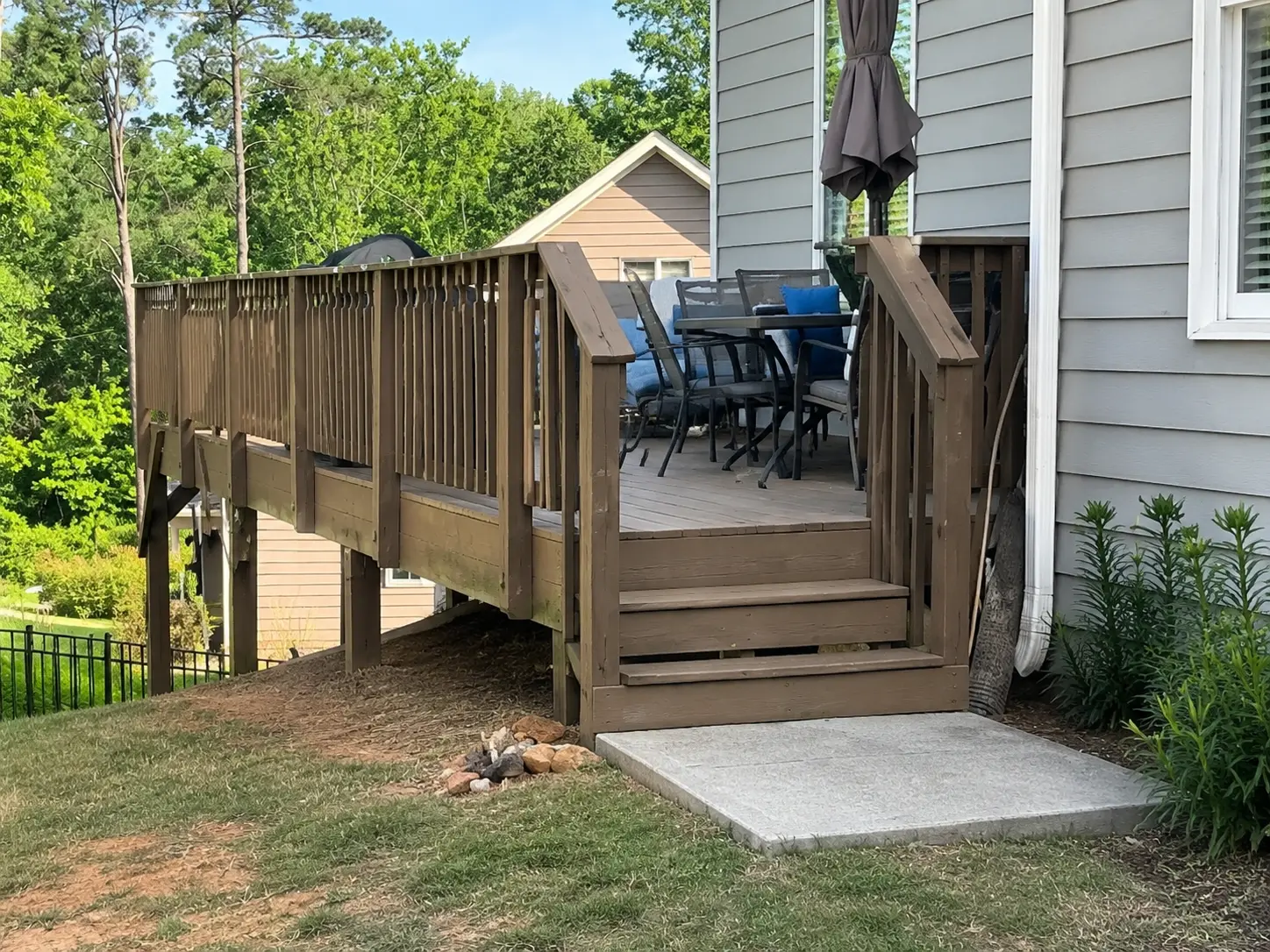 Aging builder-grade wood deck before composite deck replacement project at a North Atlanta home with elevated backyard layout and original railing system.