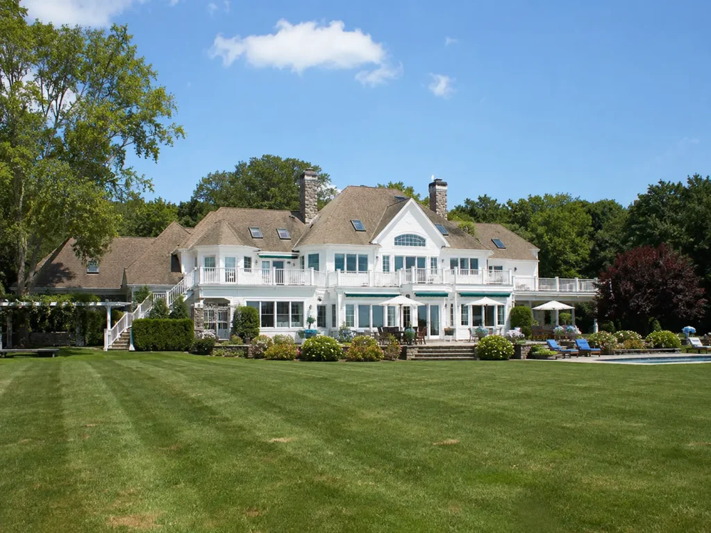 Luxury outdoor living estate in Milton GA with covered porches, elevated decks, and expansive backyard entertaining space.