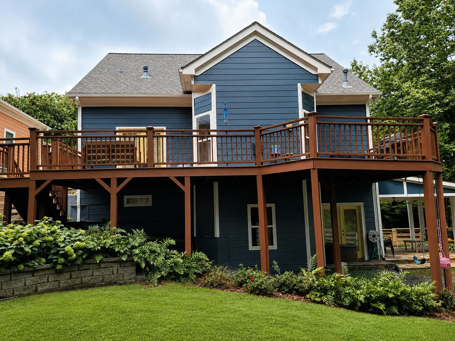 Backyard before remodeling with an aging wood deck prior to a premium composite deck and screened porch renovation in North Atlanta.