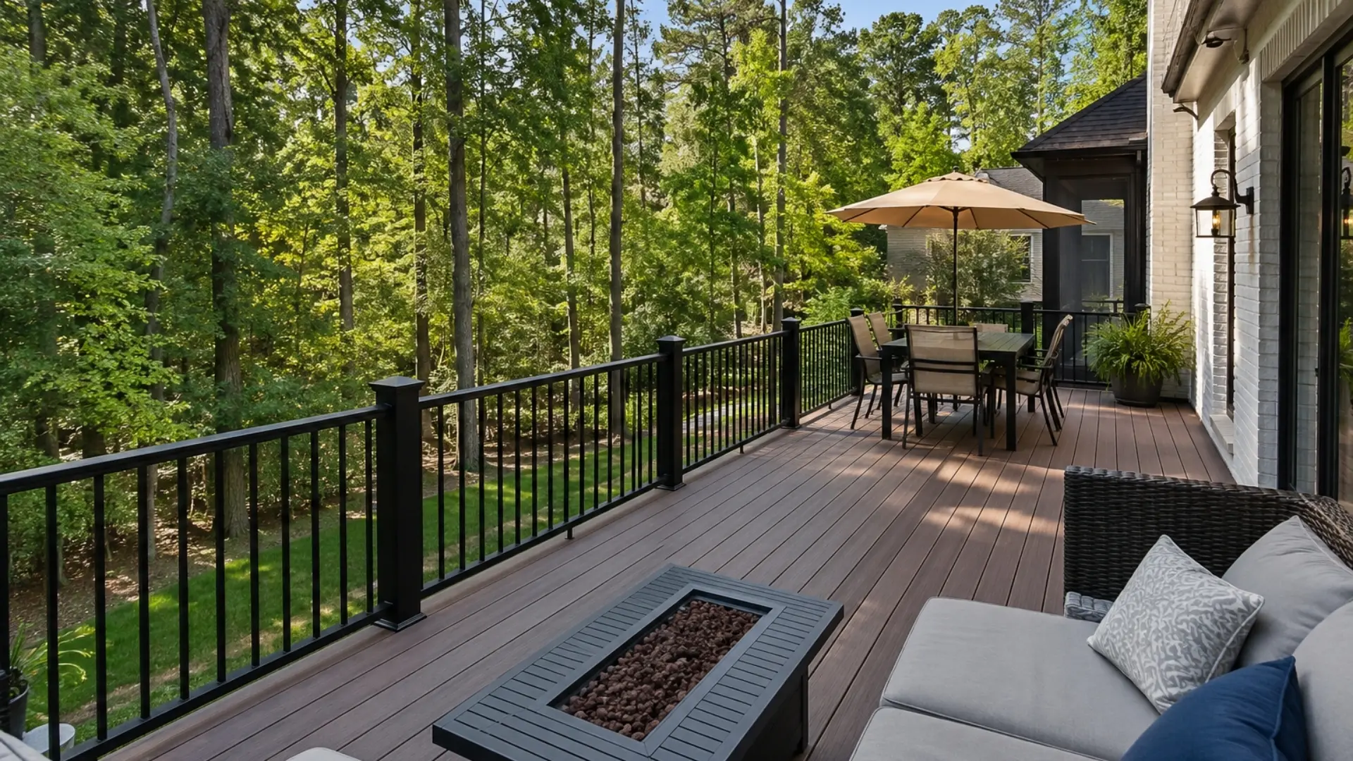 Custom composite deck in Milton, GA with black railings and outdoor living space overlooking a wooded backyard.