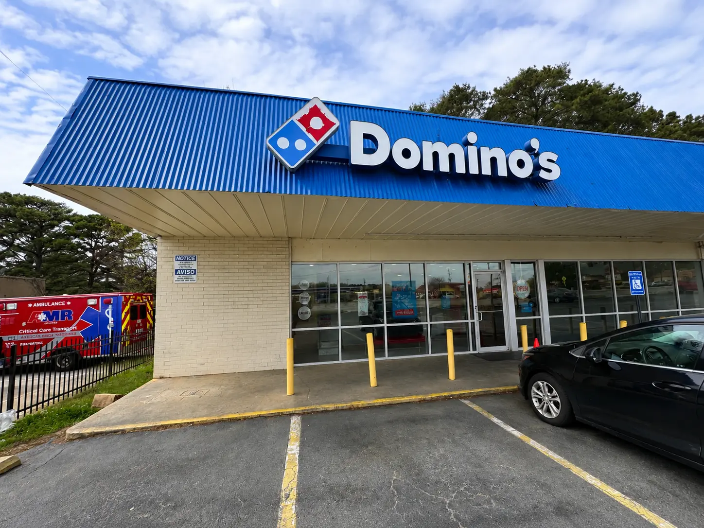 Before renovation exterior of Domino's restaurant showing the existing storefront and building facade.