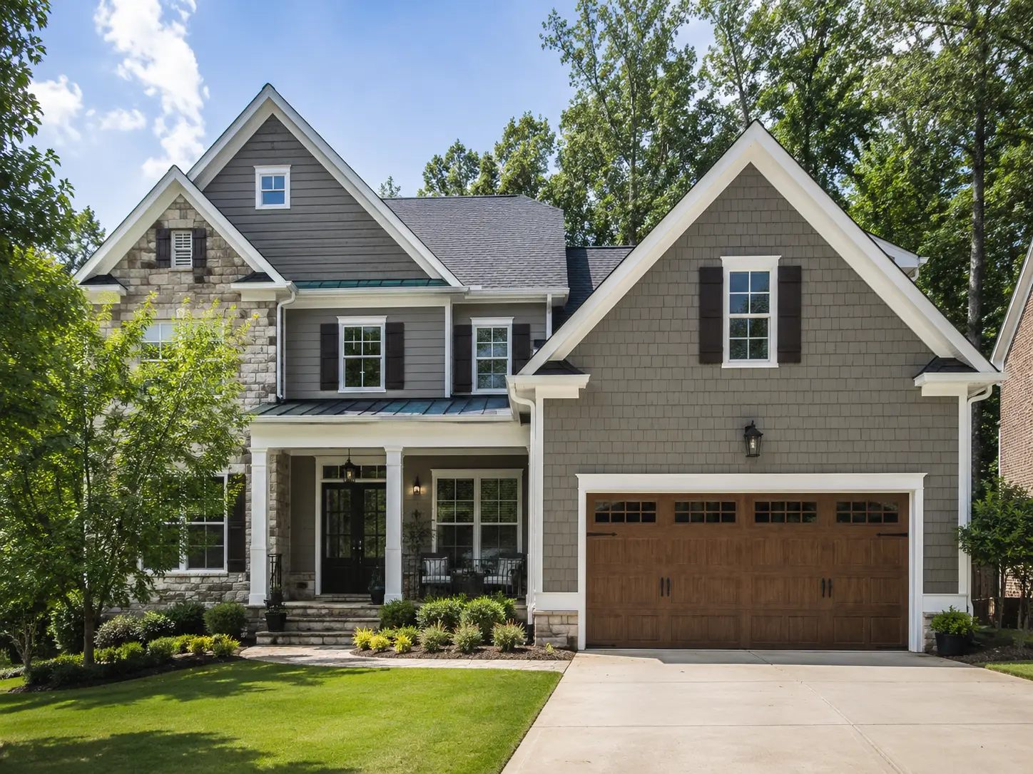 Exterior home remodel with new siding, stone accents, and updated finishes