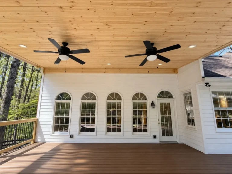 Covered porch with tongue-and-groove pine ceiling, two black ceiling fans, Trex decking and wood railing in Bethany Creek, Alpharetta, GA.