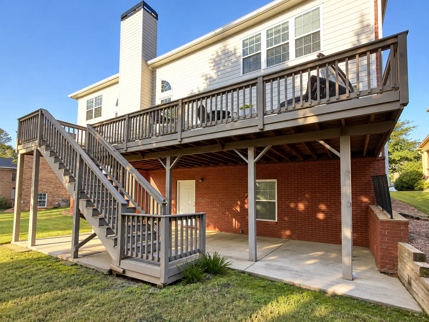 Before: Aging elevated wood deck with stairs before deck replacement in Cumming, GA
