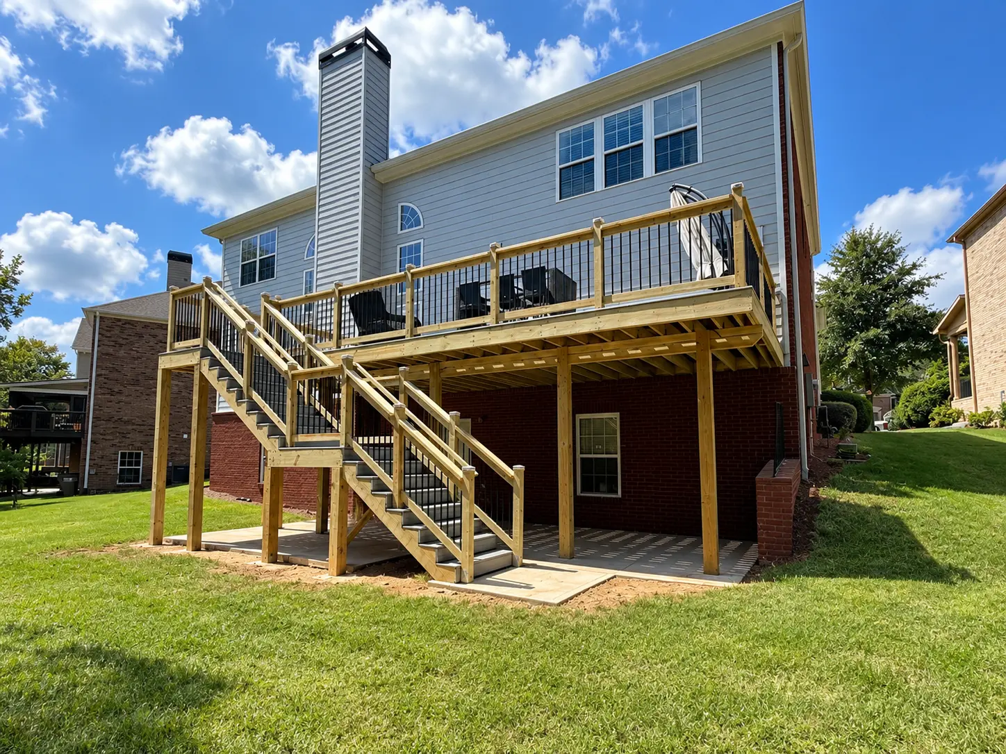 After: Completed elevated deck rebuild with new decking, railings and stairs in Cumming, GA