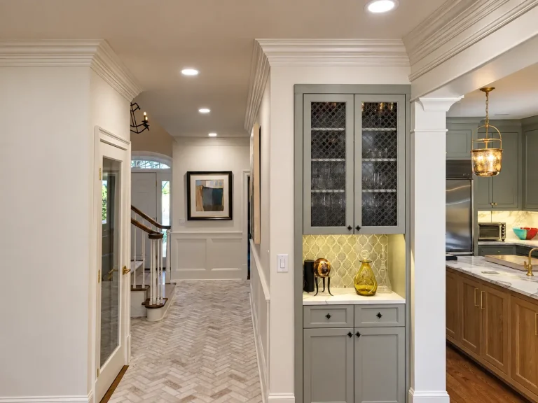 Custom gray cabinetry and display storage connecting the kitchen and hallway in a Buckhead, GA remodel.
