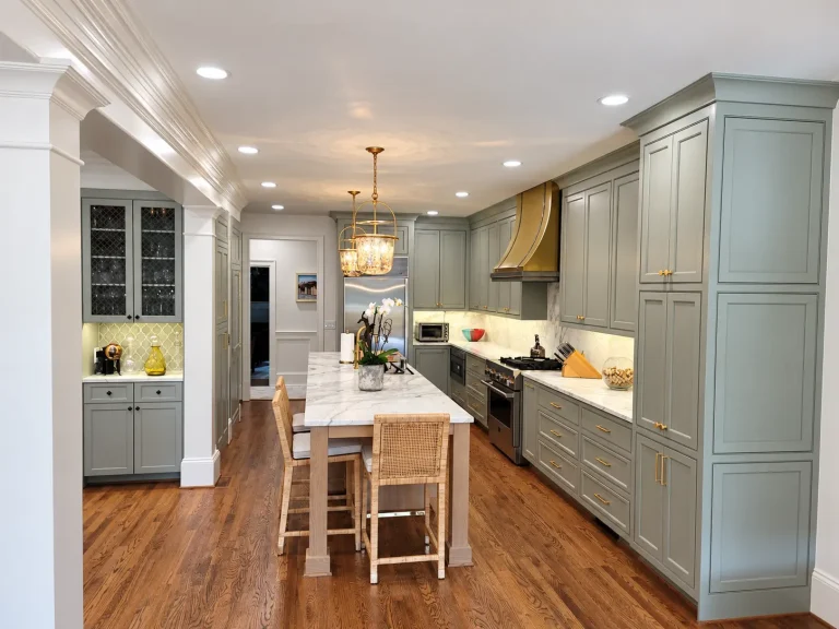 Custom kitchen remodel in Buckhead, GA with gray cabinetry, large island, stone countertops, and hardwood floors.