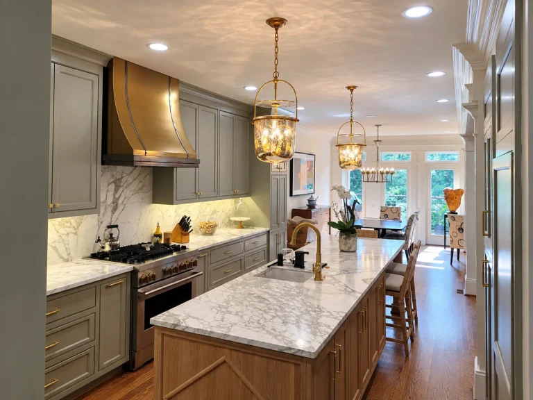 Large kitchen island with stone countertop, seating, pendant lighting, and custom cabinetry in Buckhead, GA.