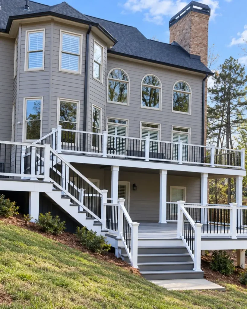 Multi-level composite deck with white posts, black railings, custom stairs, and elevated outdoor living space in Milton, GA.