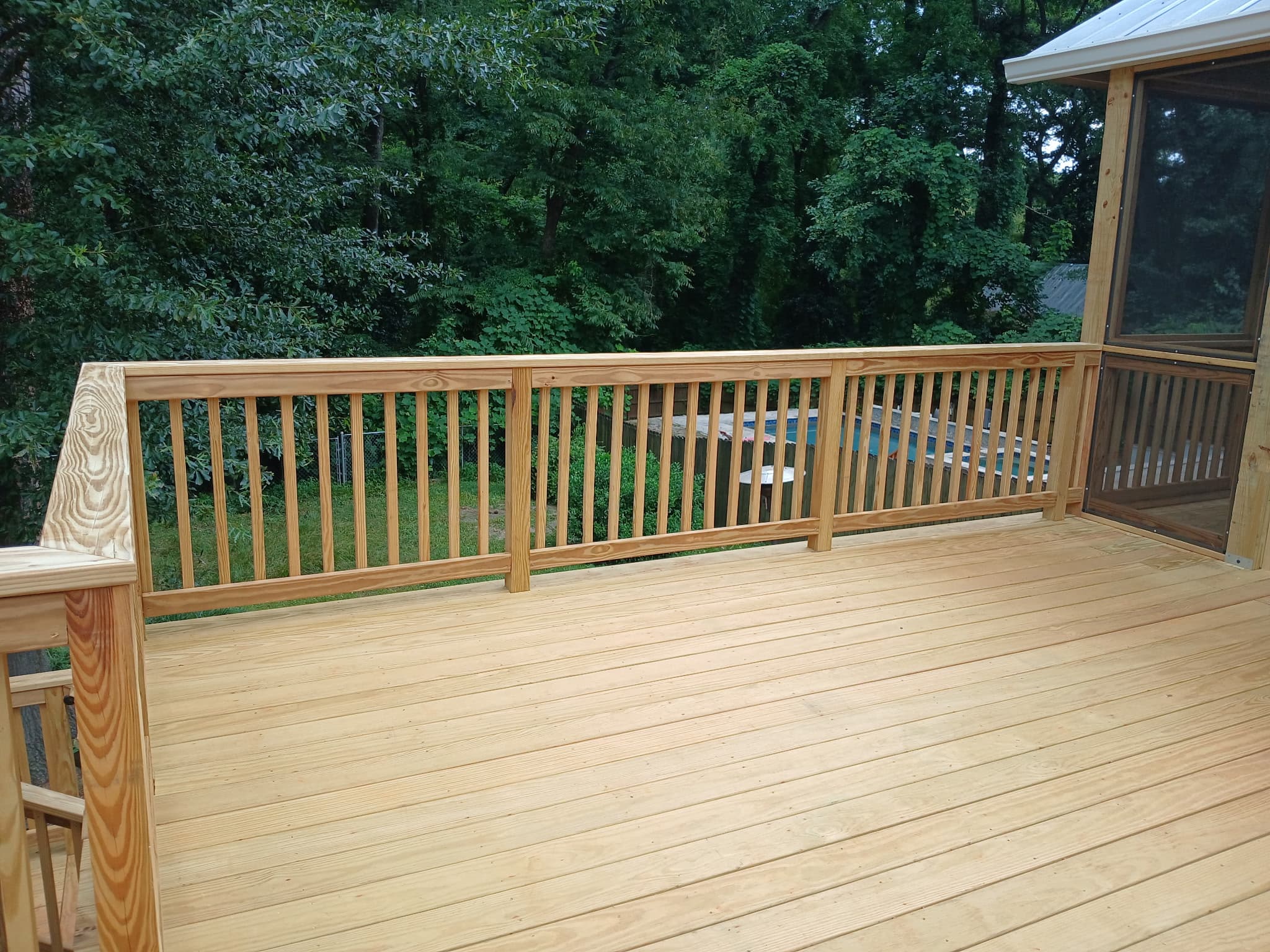 Custom wood deck with natural wood decking and railings in North Atlanta, GA.