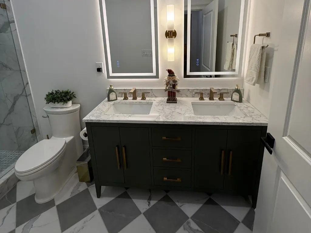 Remodeled basement bathroom with double vanity, illuminated mirrors and walk-in shower in North Atlanta