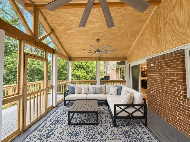 Custom screened porch with wood ceiling, exposed beams, and outdoor sectional seating